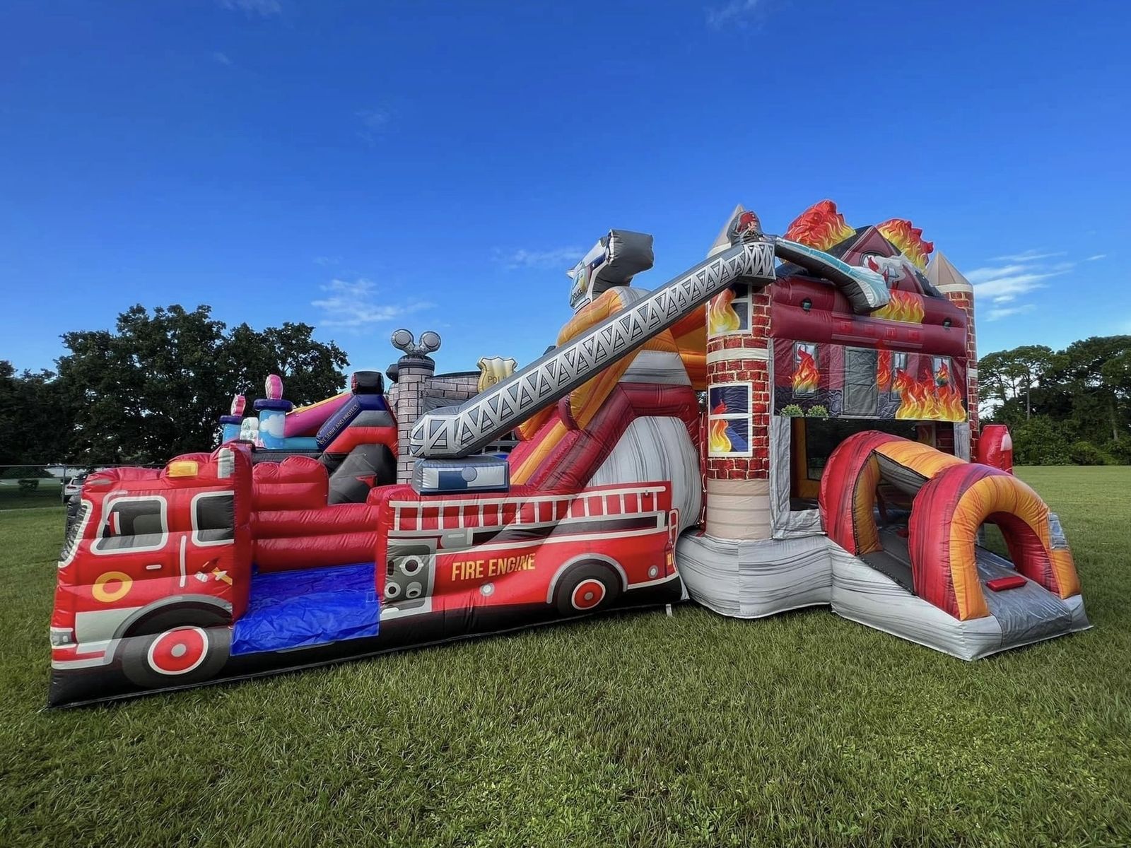 Mega Firehouse combo bounce house with dual-lane slide — real Lakeland, FL backyard setup