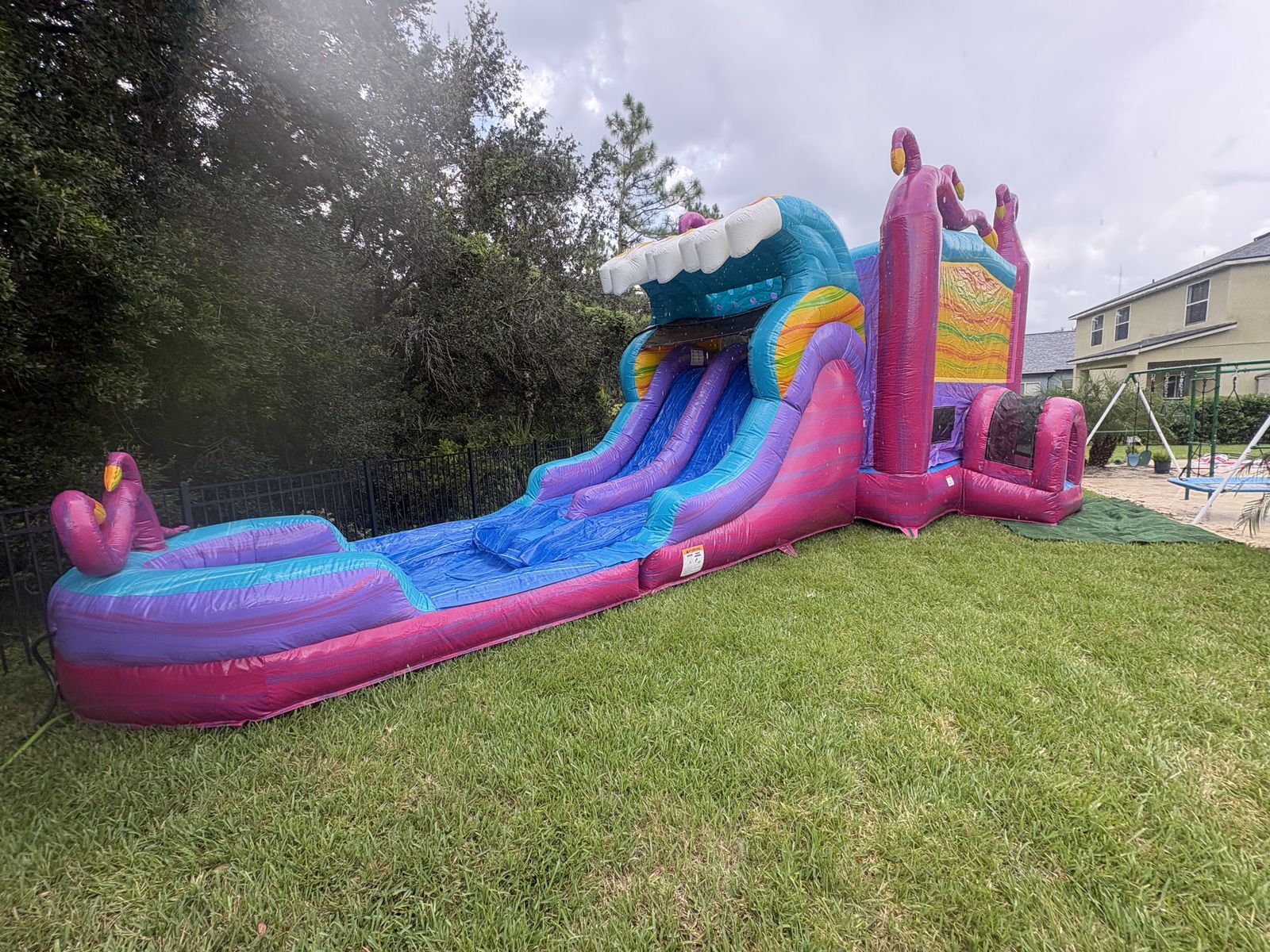 Mega Pink Jungle combo with dual-lane slide and splash pool — real backyard setup in Lakeland, FL