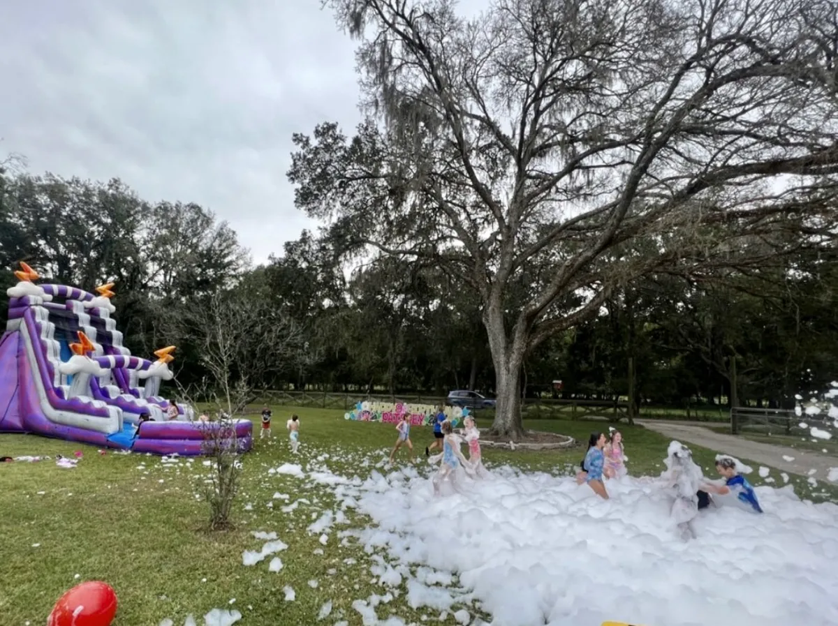 Kids enjoying a foam party with water slide rental in Lakeland, FL