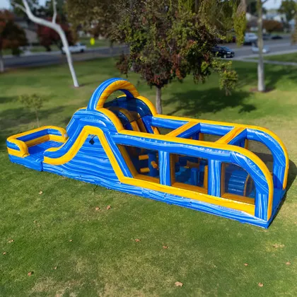Inflatable obstacle course rental set up on grass in Lakeland, FL